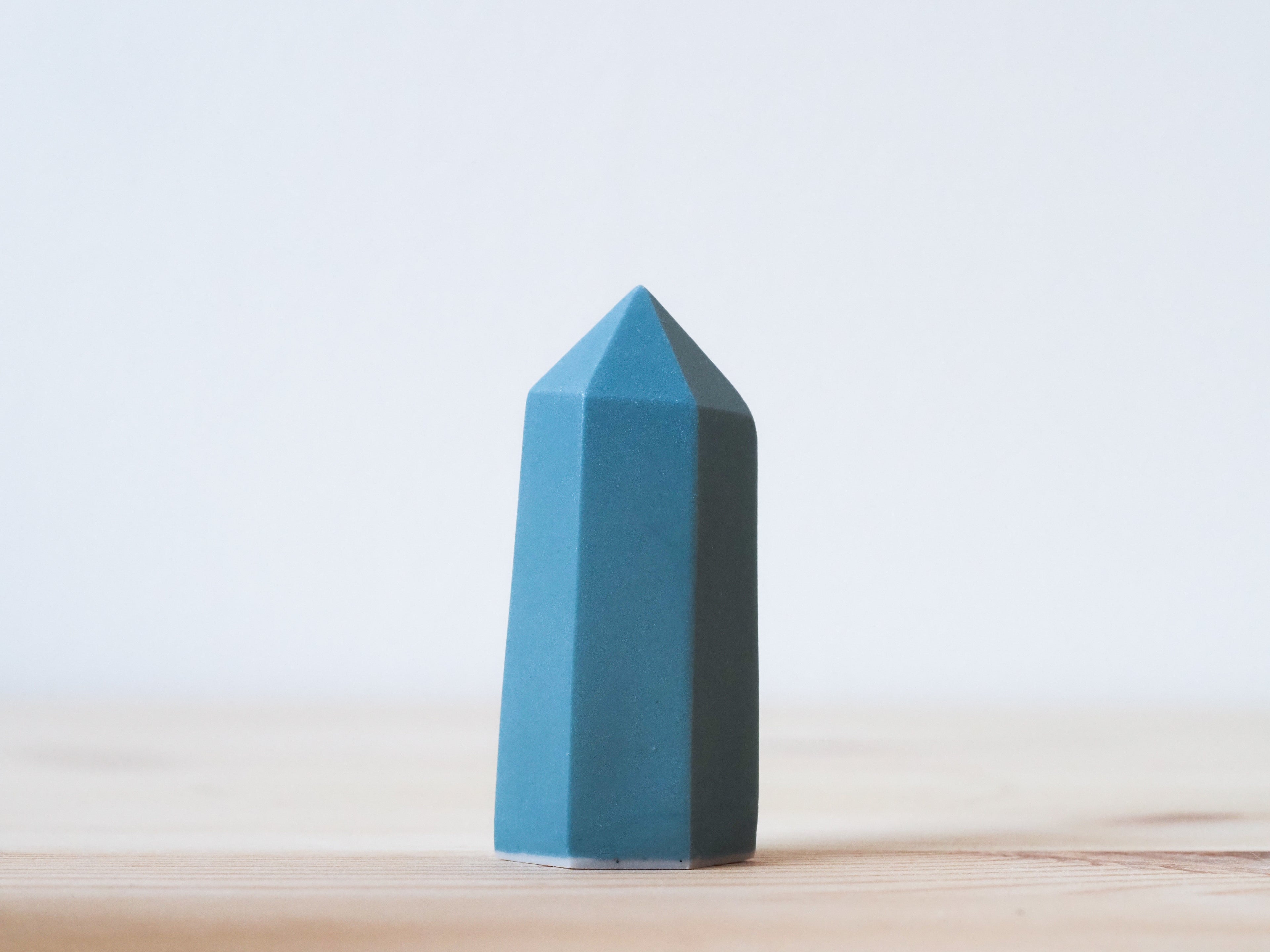 Handcrafted porcelain crystal sculpture, unique sculptural decorative piece with textured surface, subtle tints, and natural variations.