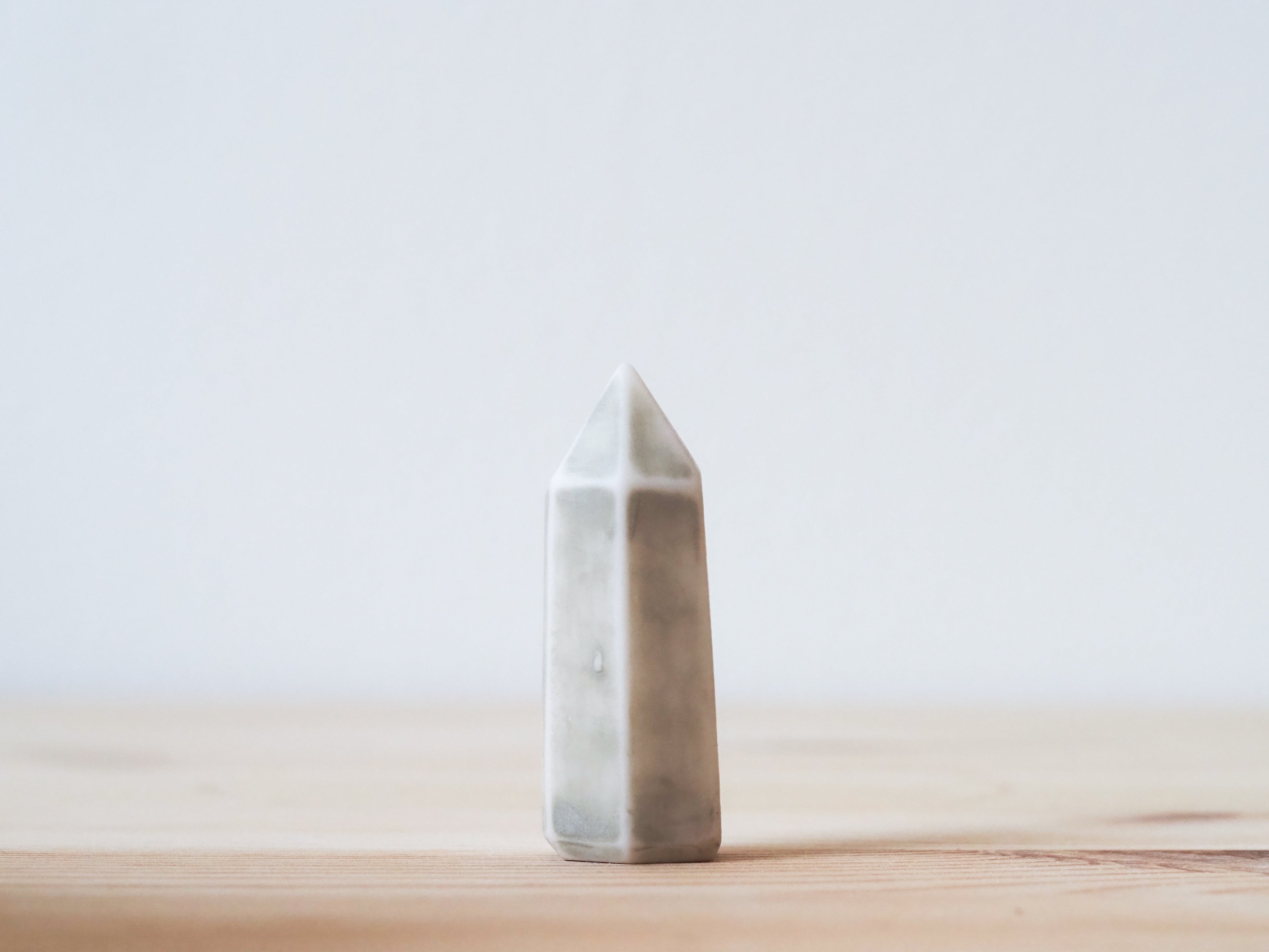 Handcrafted porcelain crystal sculpture, unique sculptural decorative piece with textured surface, subtle tints, and natural variations.