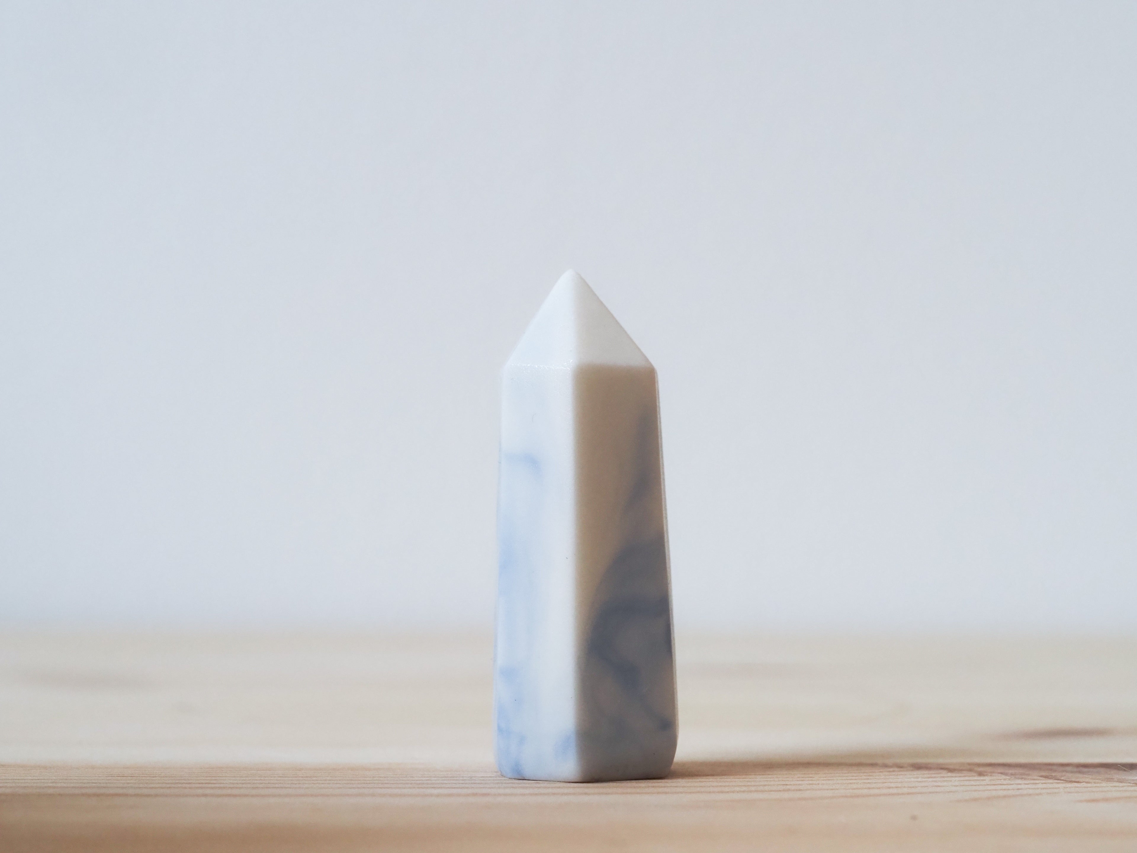 Handcrafted porcelain crystal sculpture, unique sculptural decorative piece with textured surface, subtle tints, and natural variations.