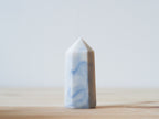 Handcrafted porcelain crystal sculpture, unique sculptural decorative piece with textured surface, subtle tints, and natural variations.
