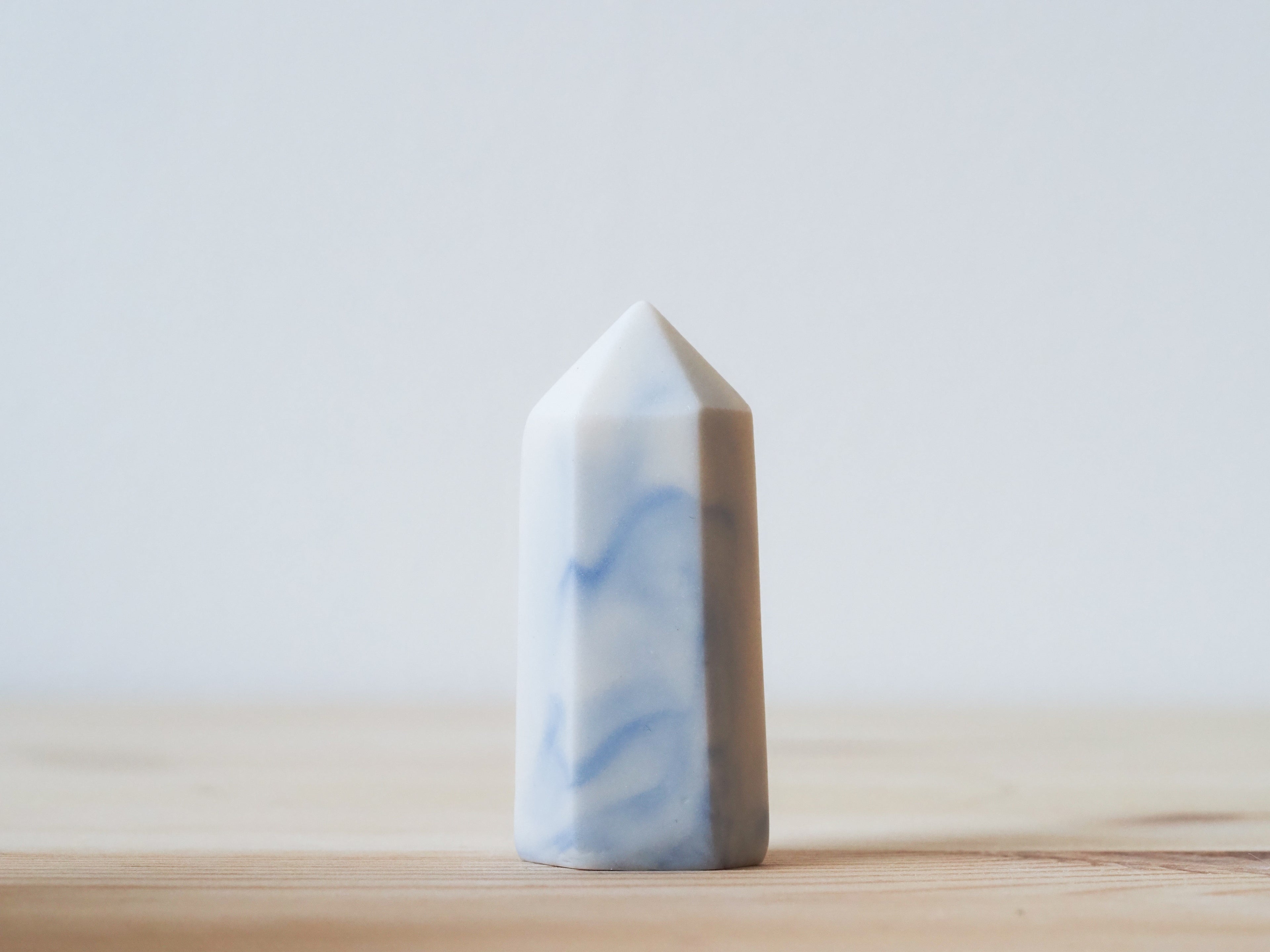 Handcrafted porcelain crystal sculpture, unique sculptural decorative piece with textured surface, subtle tints, and natural variations.