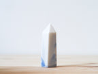 Handcrafted porcelain crystal sculpture, unique sculptural decorative piece with textured surface, subtle tints, and natural variations.