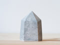 Handcrafted porcelain crystal sculpture, unique sculptural decorative piece with textured surface, subtle tints, and natural variations.