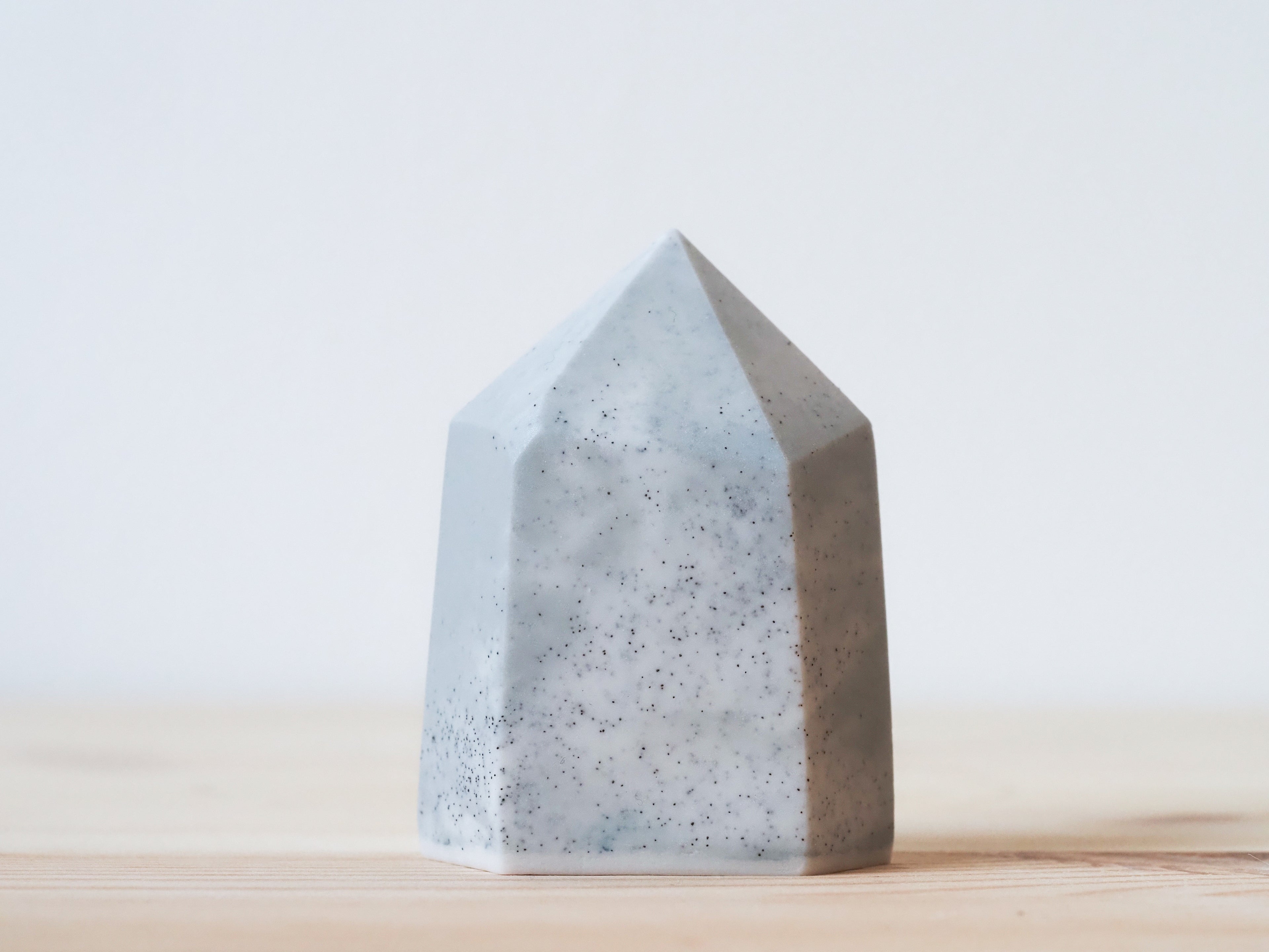 Handcrafted porcelain crystal sculpture, unique sculptural decorative piece with textured surface, subtle tints, and natural variations.