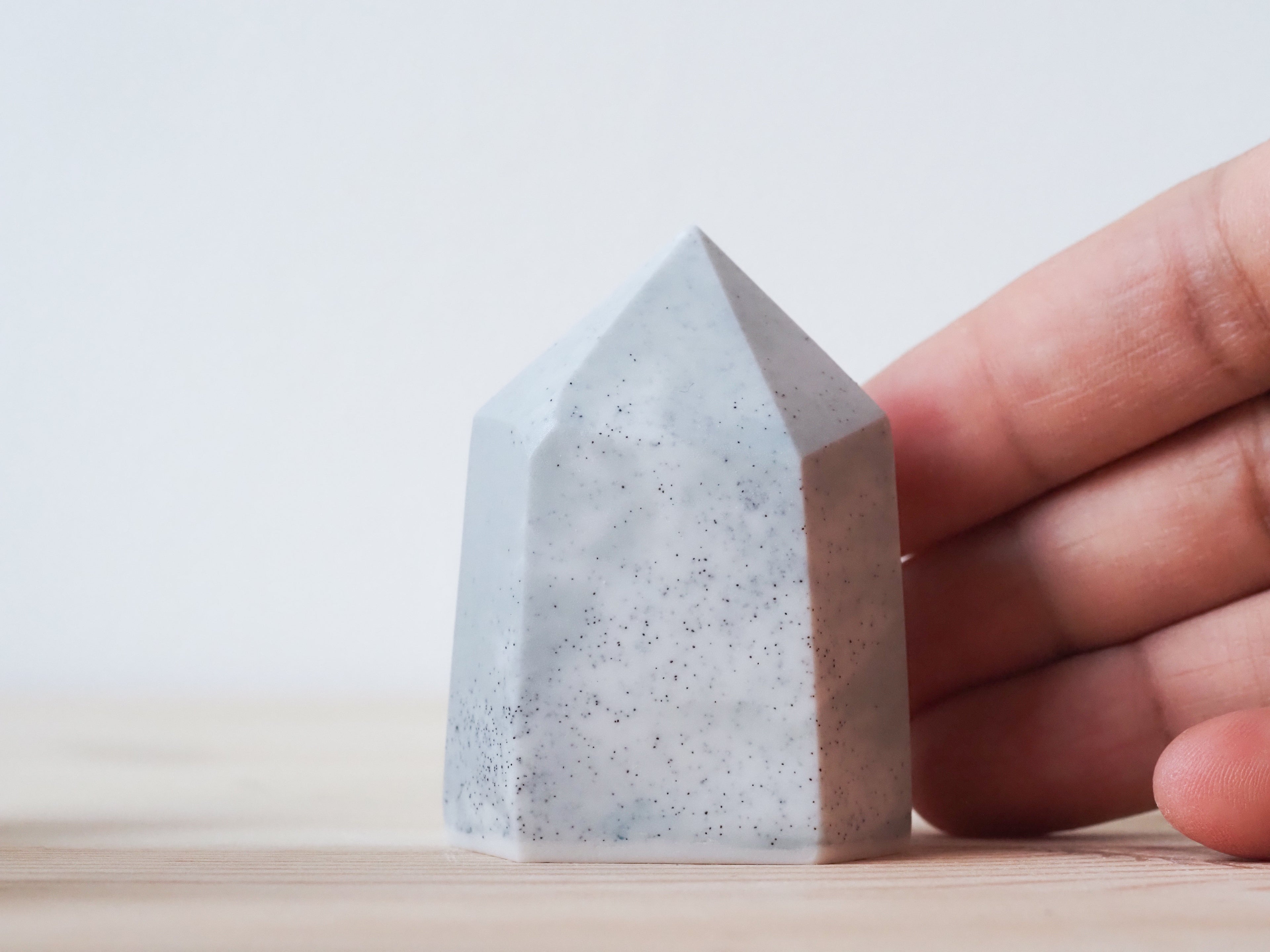 Handcrafted porcelain crystal sculpture, unique sculptural decorative piece with textured surface, subtle tints, and natural variations.