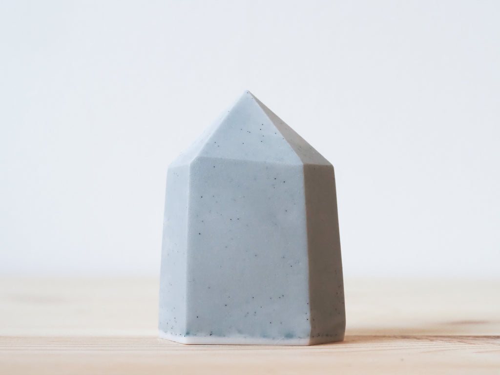 Handcrafted porcelain crystal sculpture, unique sculptural decorative piece with textured surface, subtle tints, and natural variations.