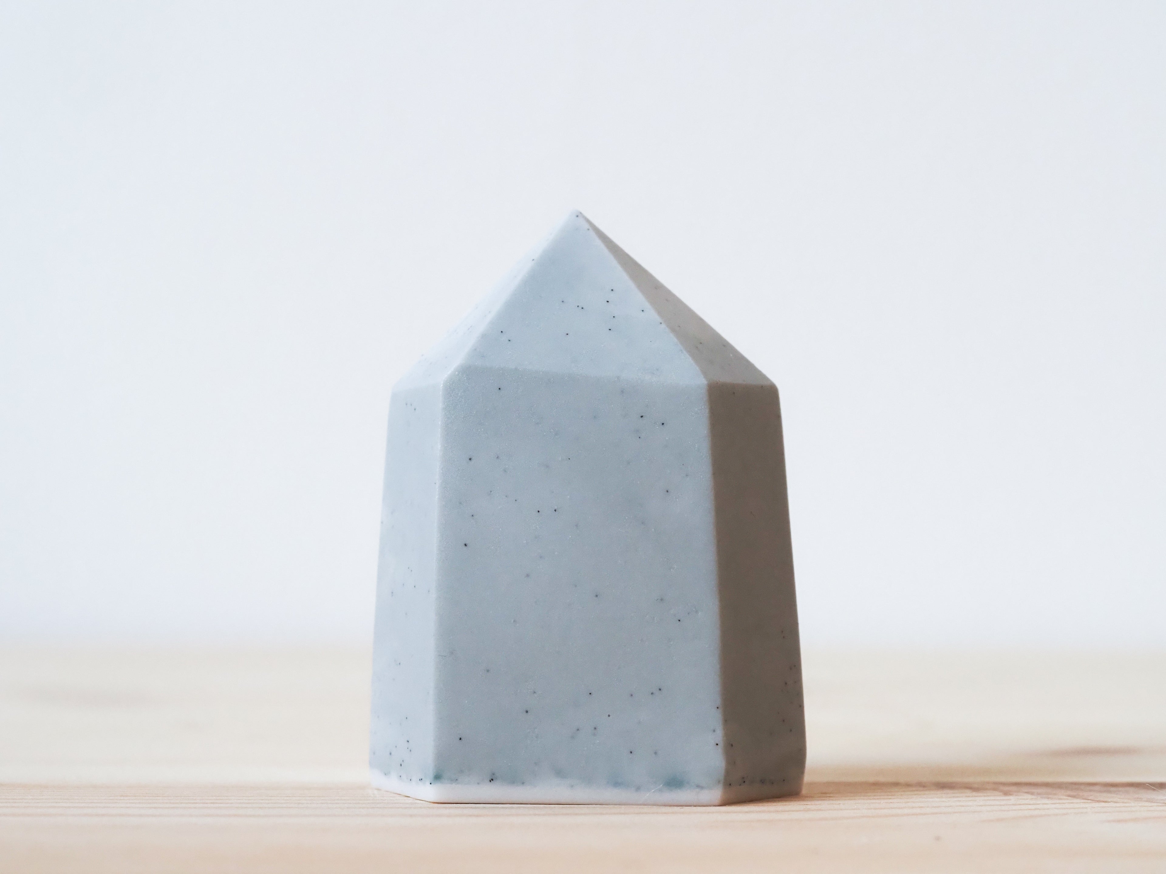 Handcrafted porcelain crystal sculpture, unique sculptural decorative piece with textured surface, subtle tints, and natural variations.