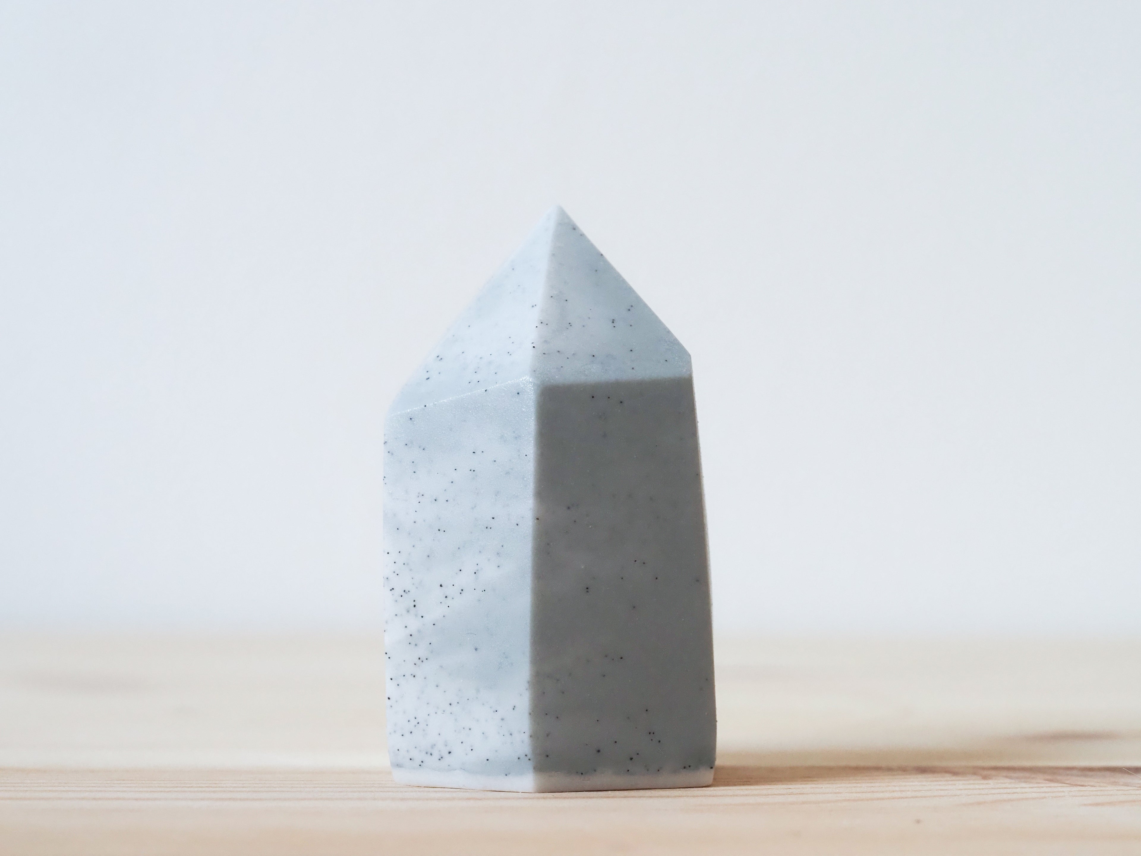 Handcrafted porcelain crystal sculpture, unique sculptural decorative piece with textured surface, subtle tints, and natural variations.