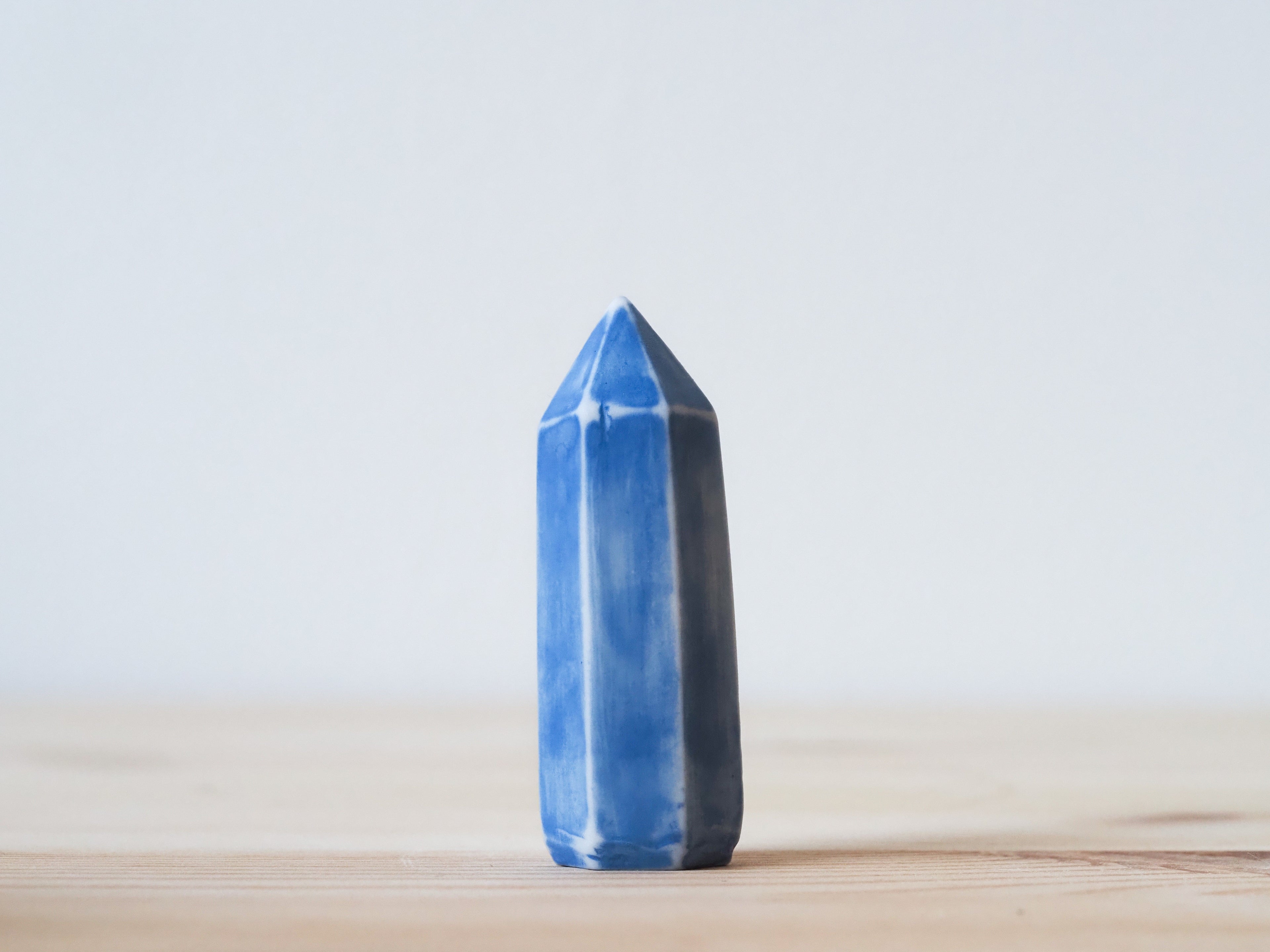 Handcrafted porcelain crystal sculpture, unique sculptural decorative piece with textured surface, subtle tints, and natural variations.