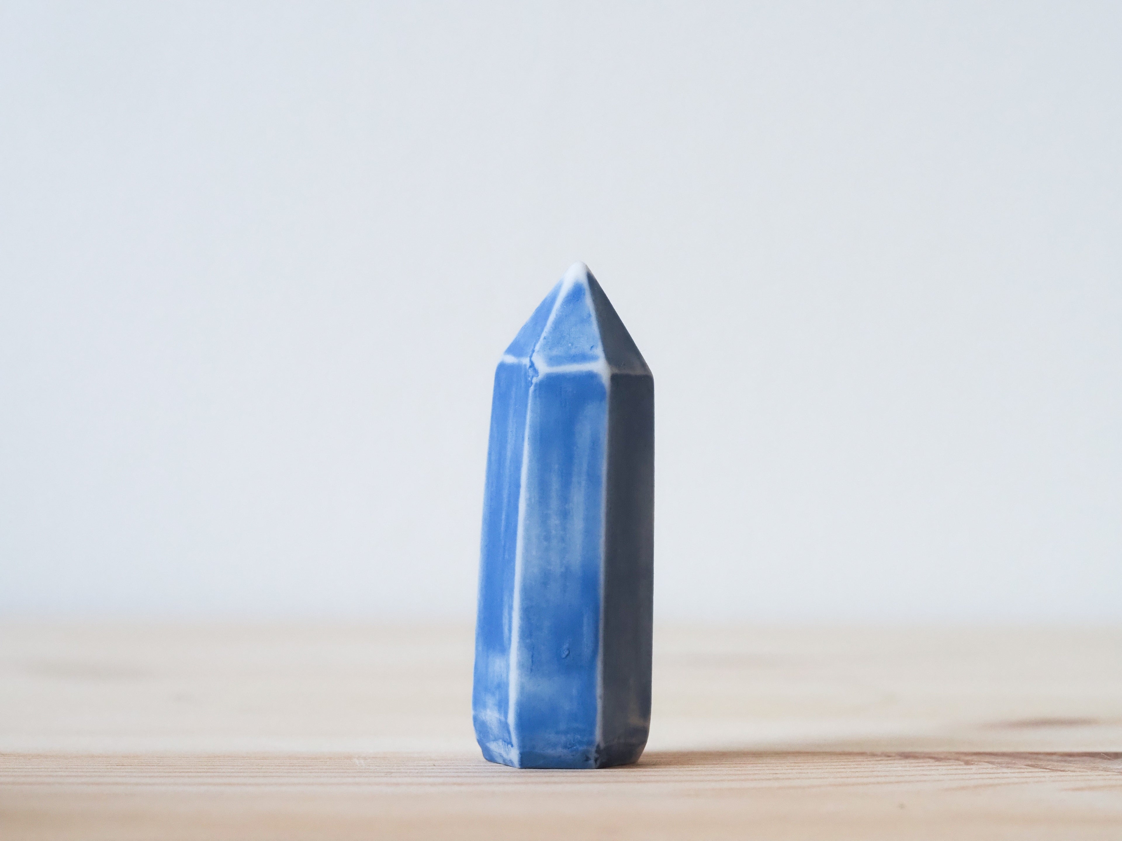 Handcrafted porcelain crystal sculpture, unique sculptural decorative piece with textured surface, subtle tints, and natural variations.