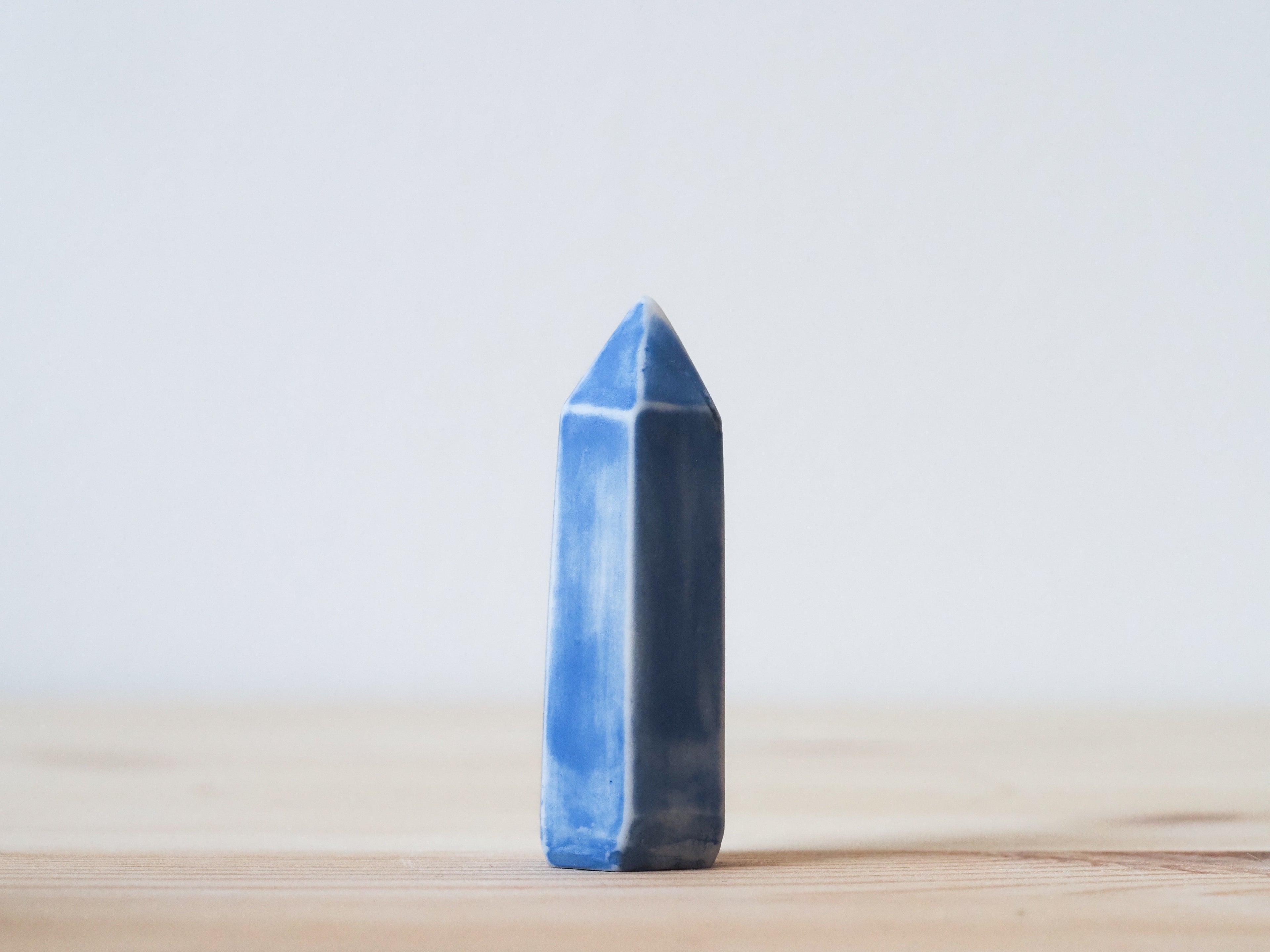 Handcrafted porcelain crystal sculpture, unique sculptural decorative piece with textured surface, subtle tints, and natural variations.