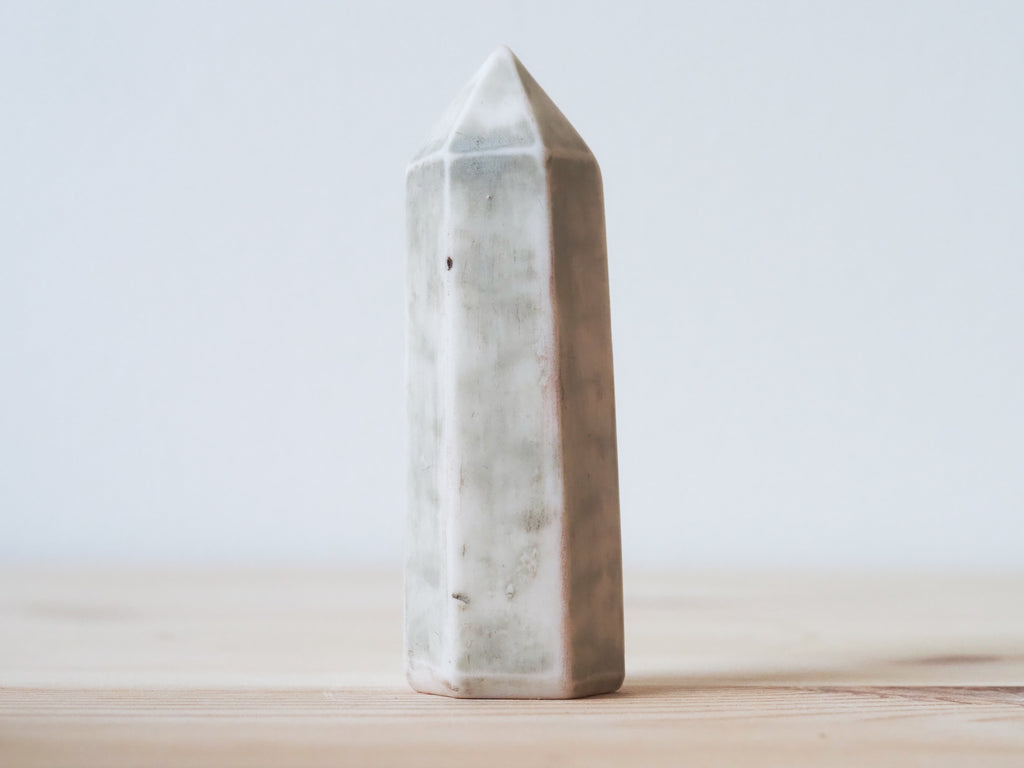 Handcrafted porcelain crystal sculpture, unique sculptural decorative piece with textured surface, subtle tints, and natural variations.
