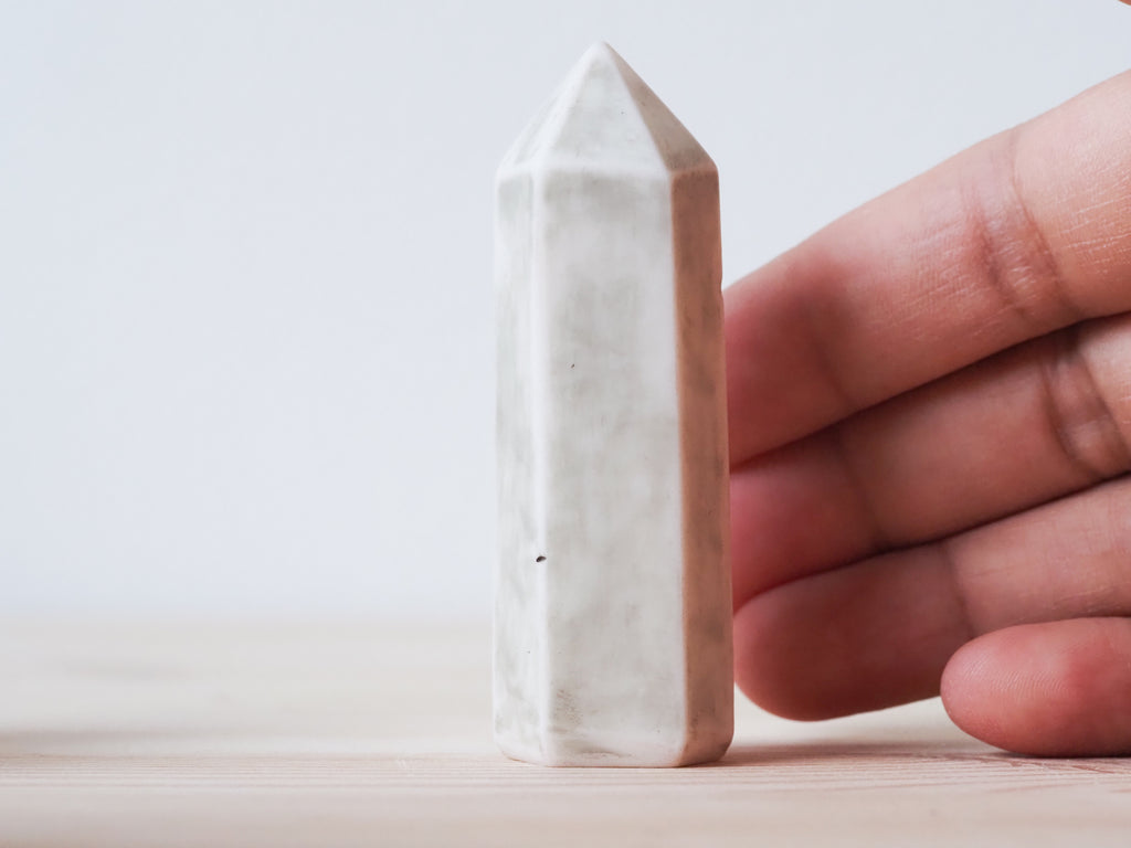 Handcrafted porcelain crystal sculpture, unique sculptural decorative piece with textured surface, subtle tints, and natural variations.
