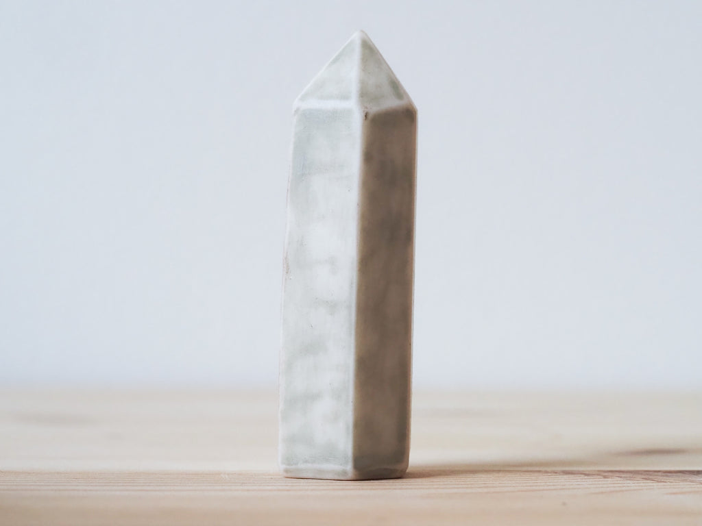 Handcrafted porcelain crystal sculpture, unique sculptural decorative piece with textured surface, subtle tints, and natural variations.