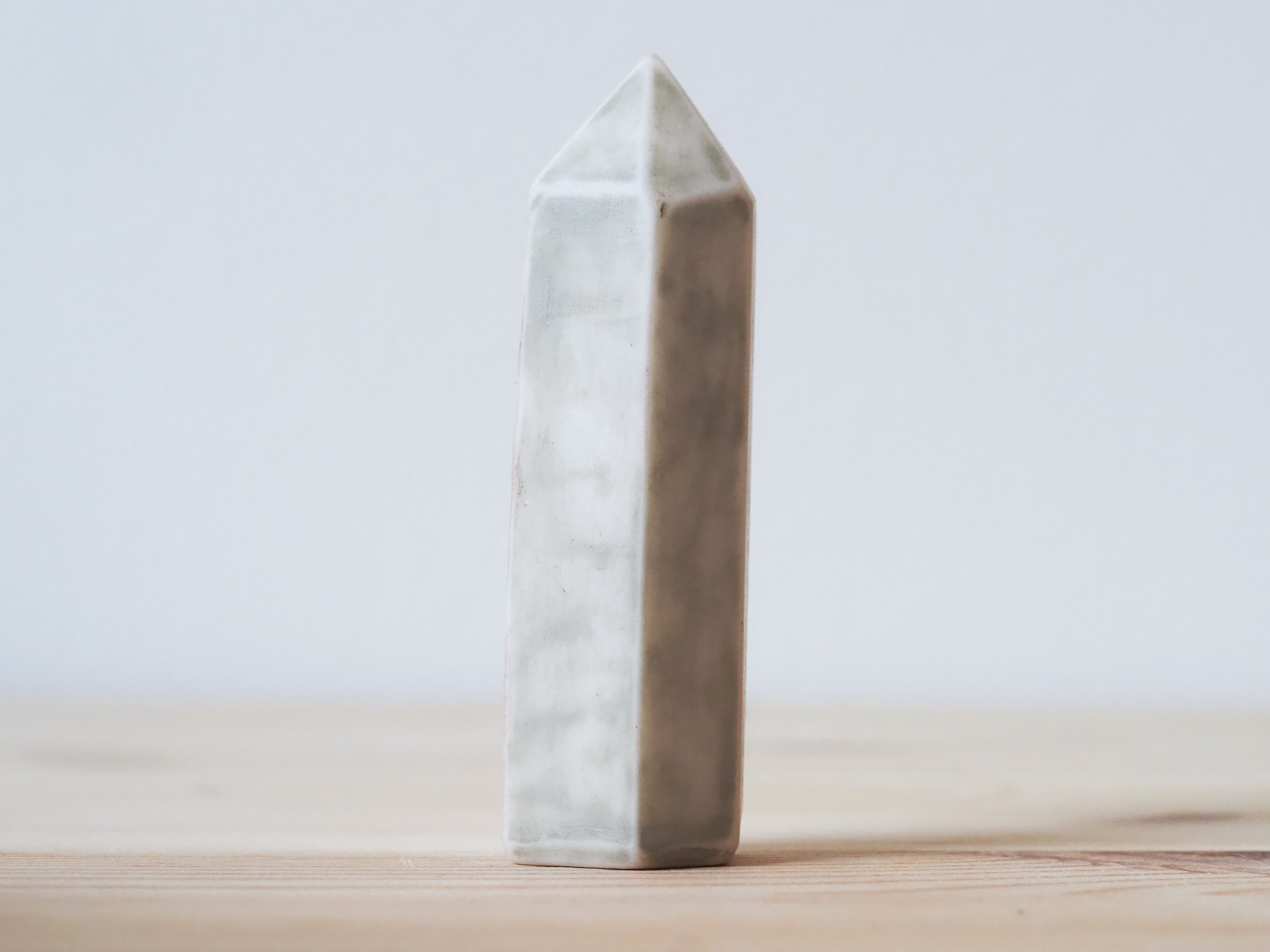 Handcrafted porcelain crystal sculpture, unique sculptural decorative piece with textured surface, subtle tints, and natural variations.