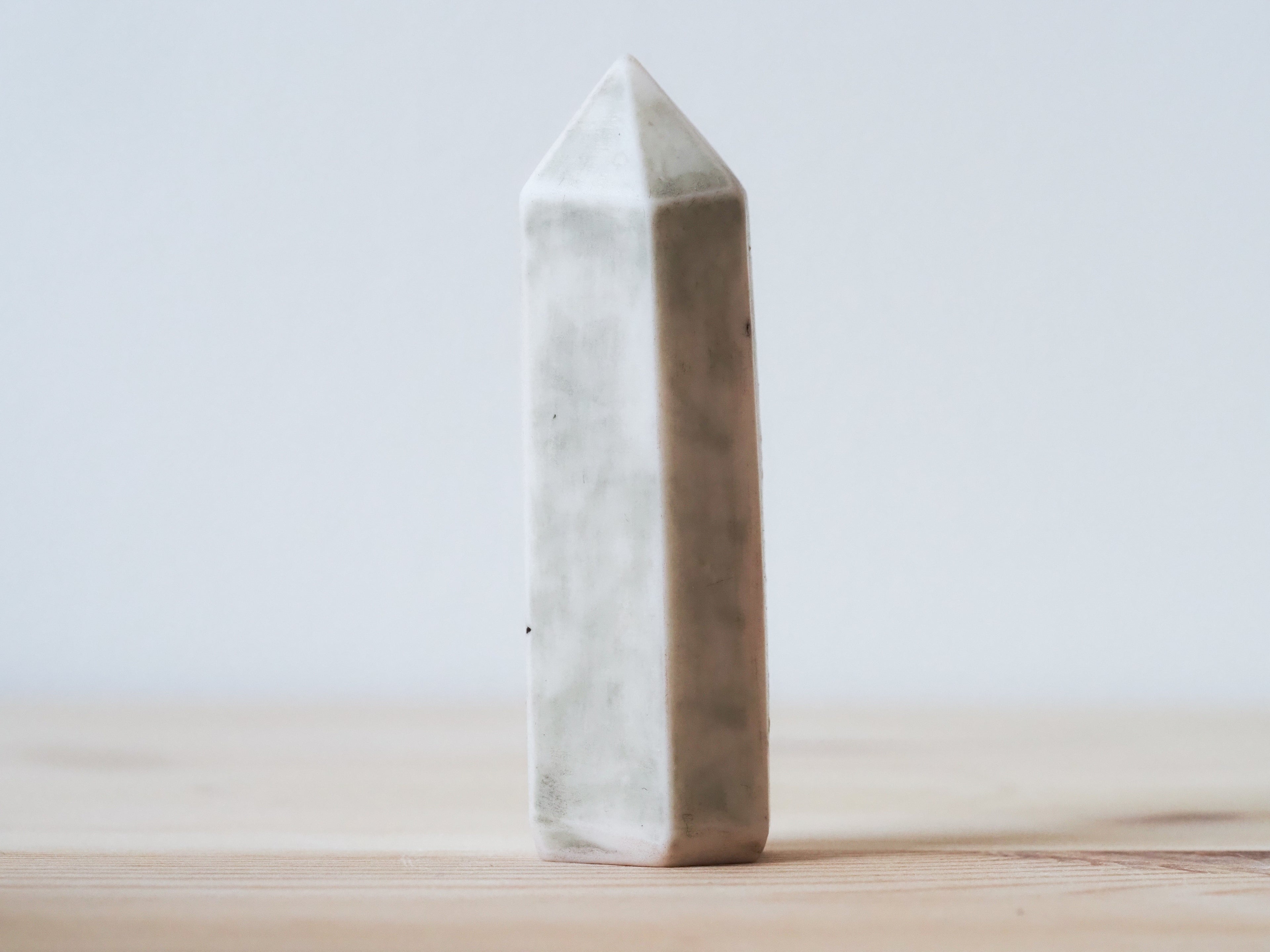 Handcrafted porcelain crystal sculpture, unique sculptural decorative piece with textured surface, subtle tints, and natural variations.