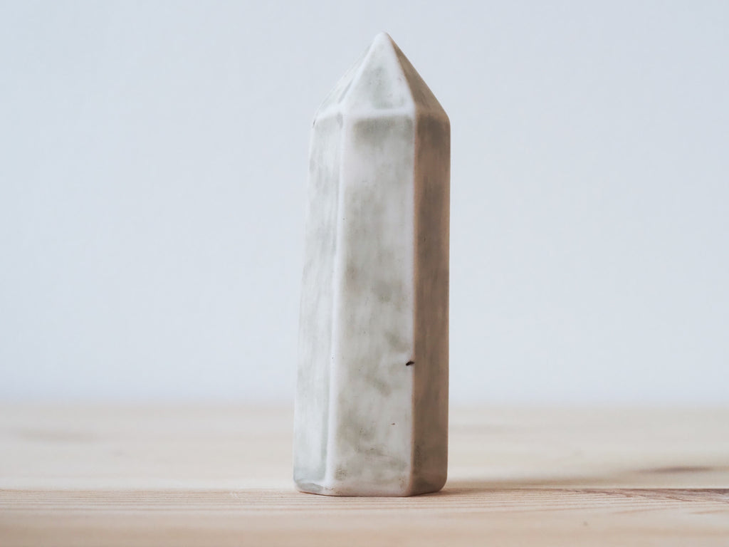 Handcrafted porcelain crystal sculpture, unique sculptural decorative piece with textured surface, subtle tints, and natural variations.