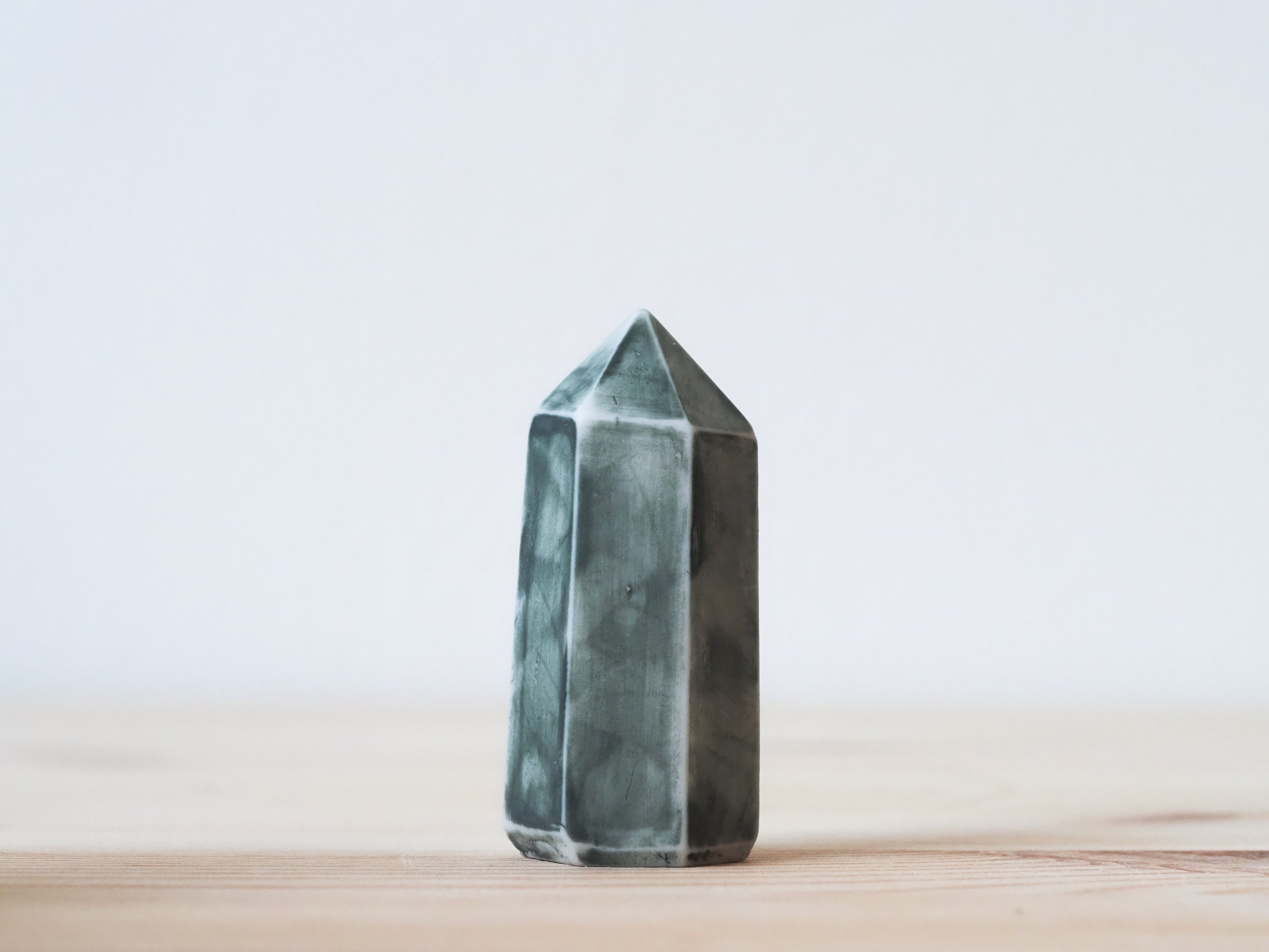 Handcrafted porcelain crystal sculpture, unique sculptural decorative piece with textured surface, subtle tints, and natural variations.