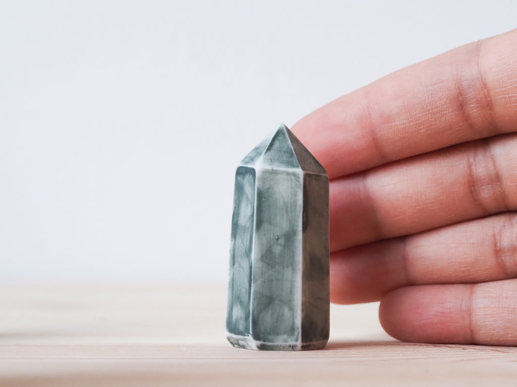 Handcrafted porcelain crystal sculpture, unique sculptural decorative piece with textured surface, subtle tints, and natural variations.