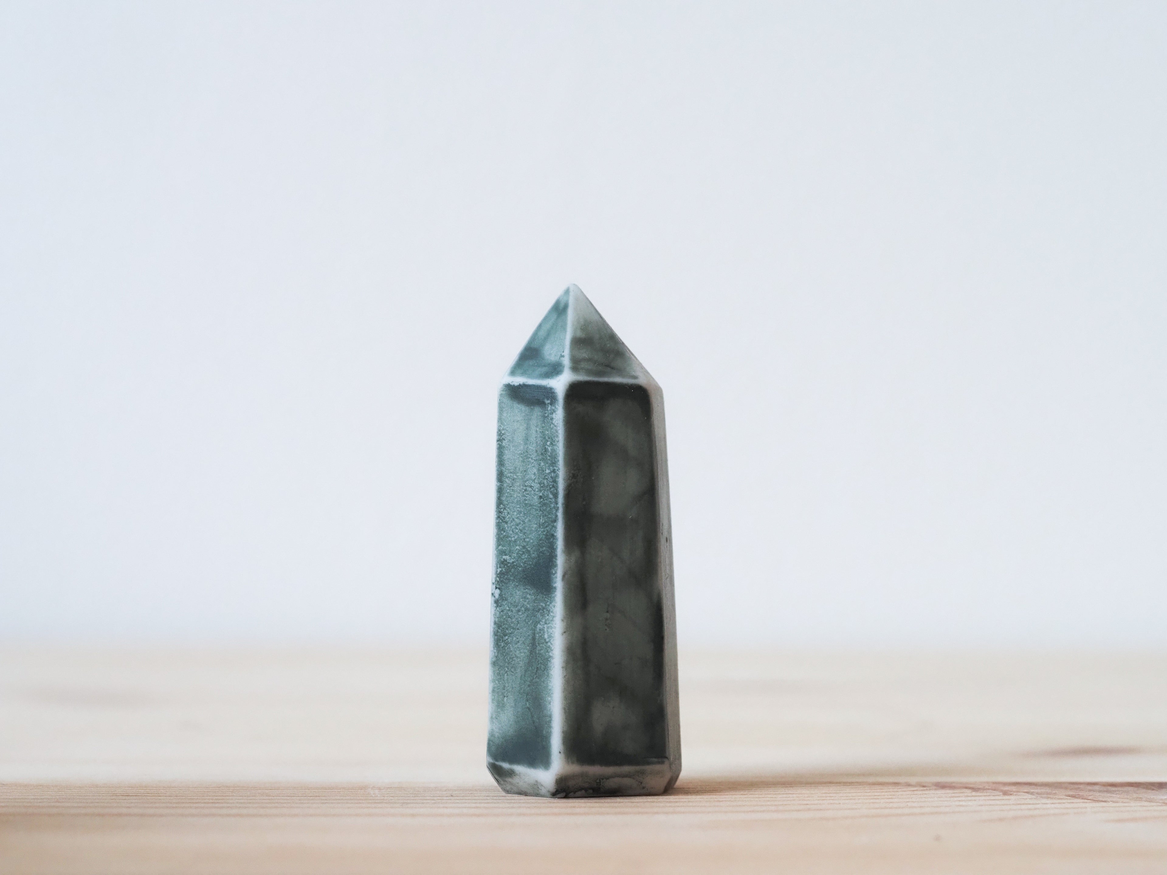 Handcrafted porcelain crystal sculpture, unique sculptural decorative piece with textured surface, subtle tints, and natural variations.