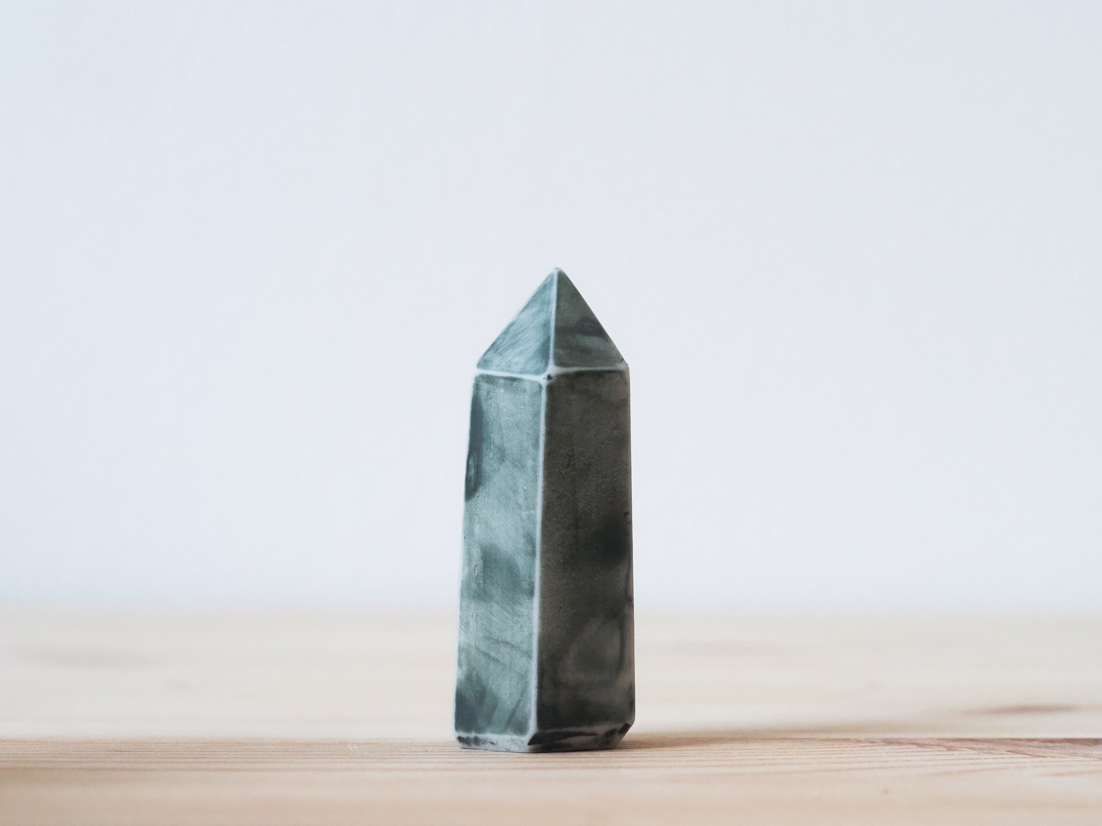 Handcrafted porcelain crystal sculpture, unique sculptural decorative piece with textured surface, subtle tints, and natural variations.