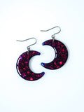 Luna moon drop earrings in night blue with pink holographic glitter on a white background