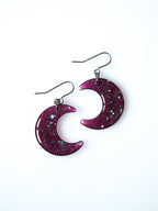 Luna moon drop earrings in transparent purple with iridescent glitter on a white background