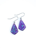 Persephone drop earrings in purple with iridescent colour shifting glitter on a white background