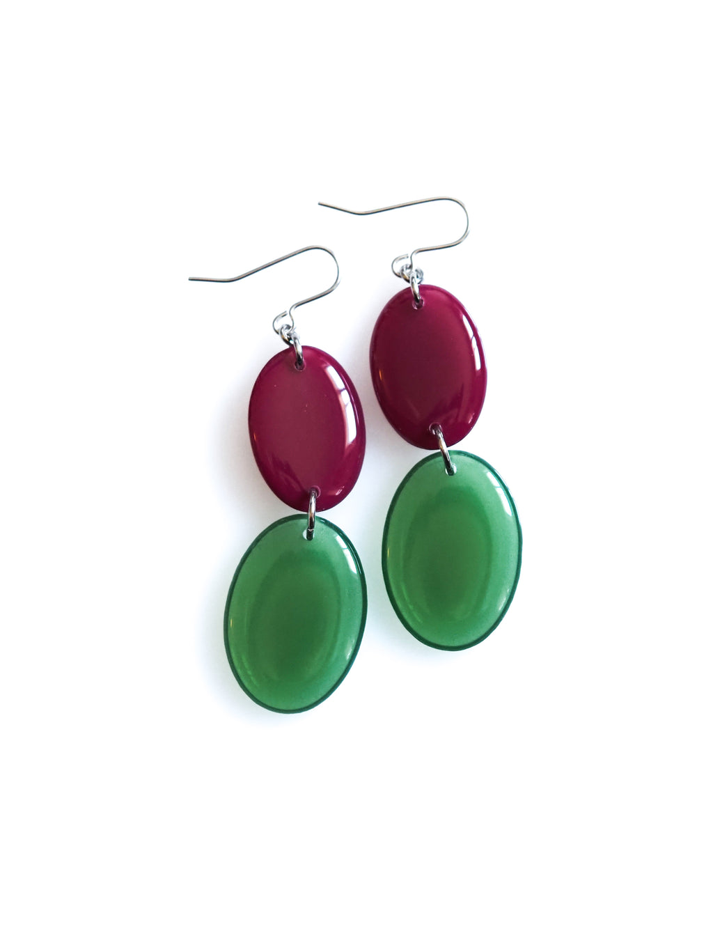 Duet resin drop earrings from the Chroma collection in mulberry and transparent forest green on a white background