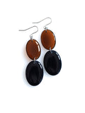 Duet resin drop earrings from the Chroma collection in transparent burnt umber and ink blue on a white background