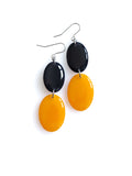 Duet resin drop earrings from the Chroma collection in ink blue and marigold yellow on a white background