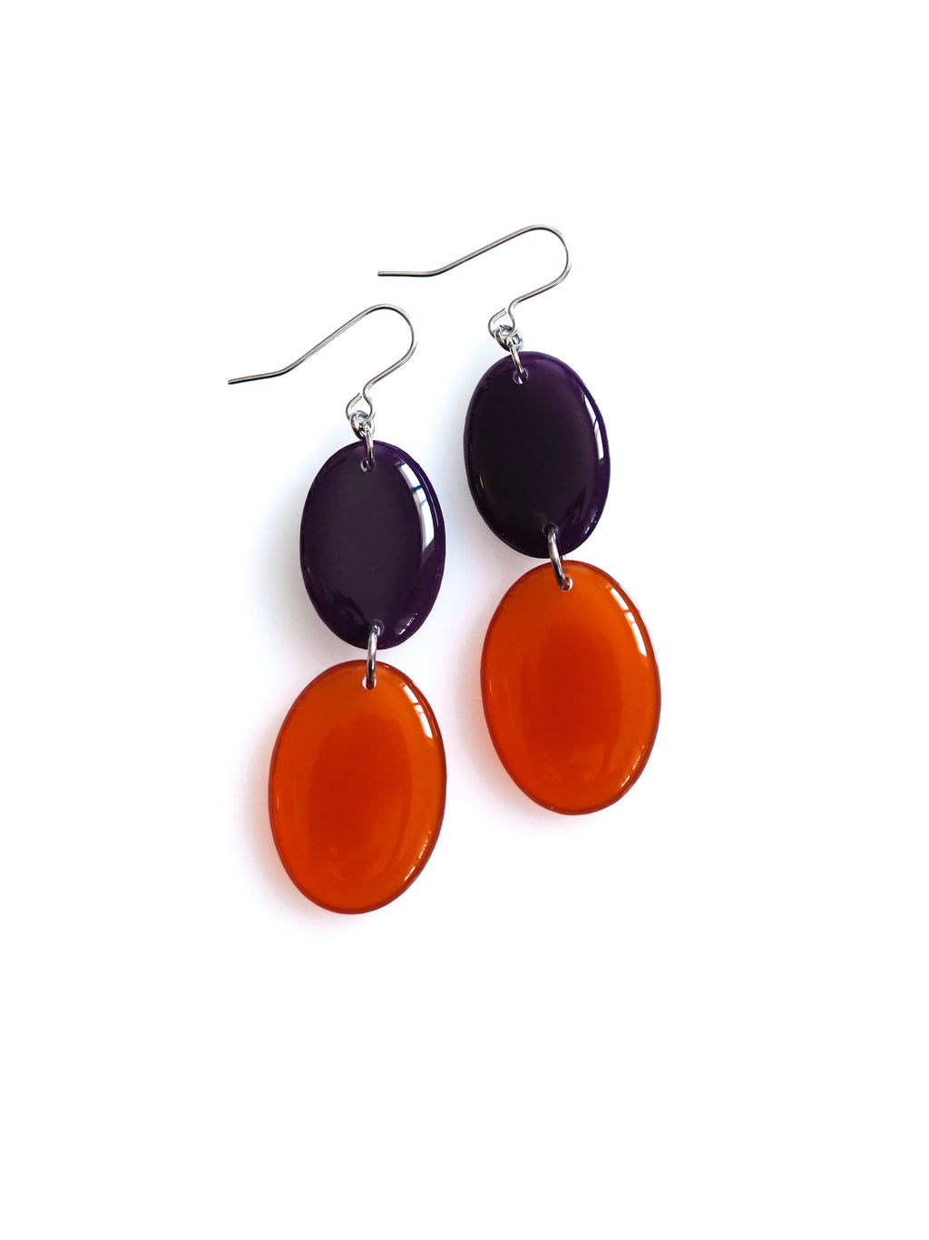 Duet resin drop earrings from the Chroma collection in aubergine and transparent rust on a white background
