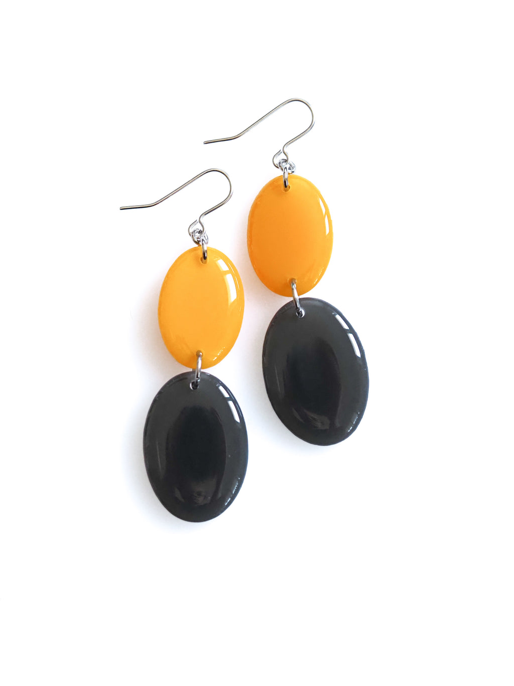 Duet resin drop earrings from the Chroma collection in marigold yellow and charcoal grey on a white background
