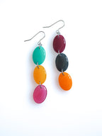 Sequence resin drop earrings from the Chroma collection in turquoise, translucent orange, orange, transparent mulberry, mulberry and petrol grey on a white background