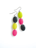 Sequence resin drop earrings from the Chroma collection in petrol grey, electric lichen and candy pink on a white background