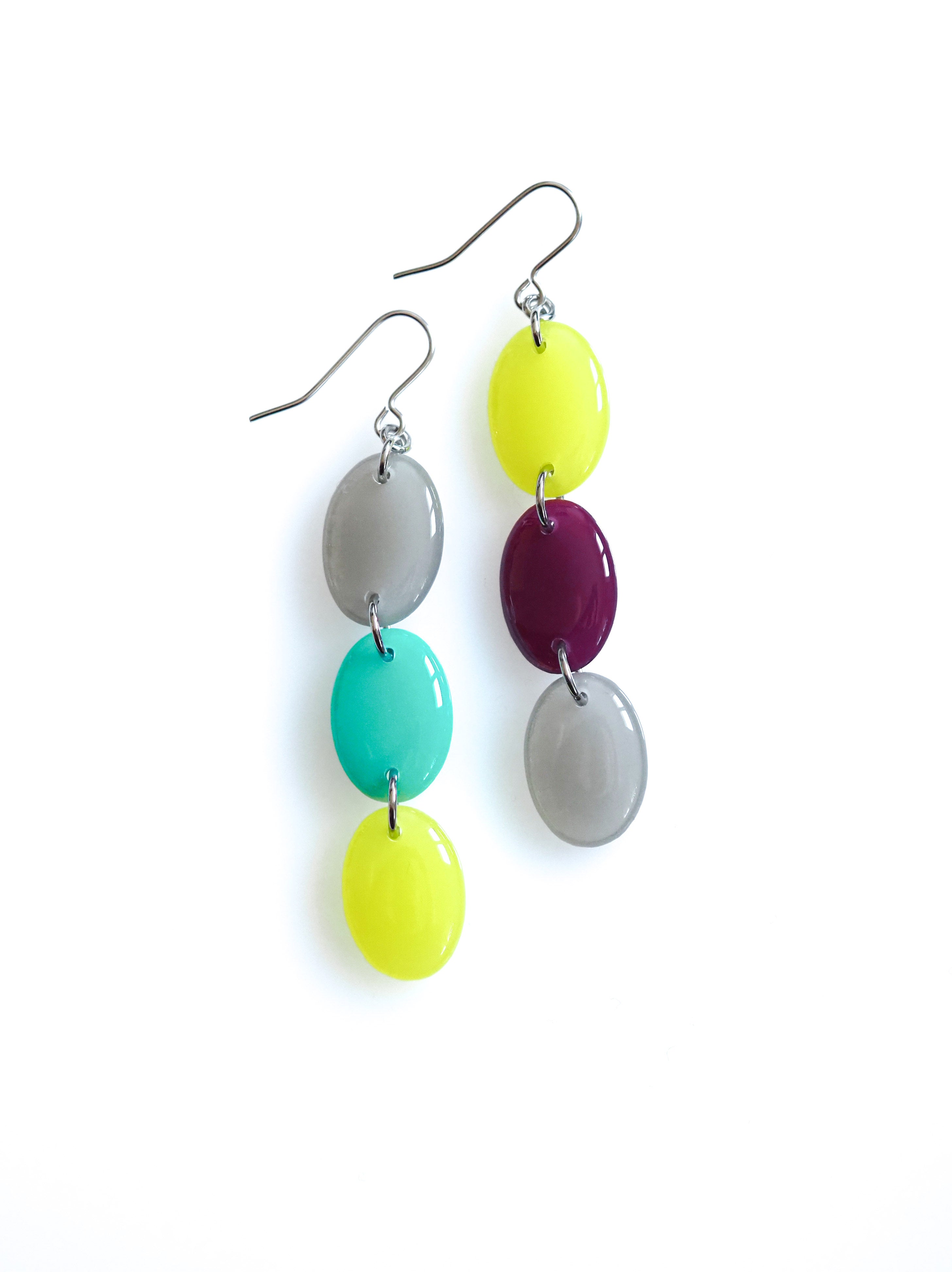 Sequence resin drop earrings from the Chroma collection in mist grey, turquoise, translucent electric lichen and mulberry on a white background