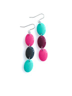 Sequence resin drop earrings from the Chroma collection in candy pink, petrol grey, turquoise and mulberry on a white background