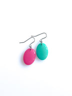 Solo resin drop earrings from the Chroma collection in candy pink and turquoise on a white background