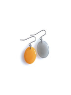 Solo resin drop earrings from the Chroma collection in marigold yellow and mist grey on a white background