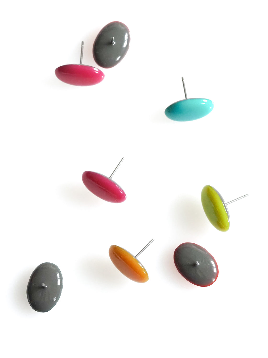 Solo resin stud earrings from the Chroma collection multiple colours scattered on a white background