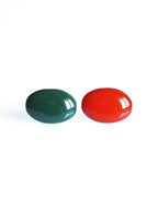 Solo resin stud earrings from the Chroma collection in forest green and red on a white background