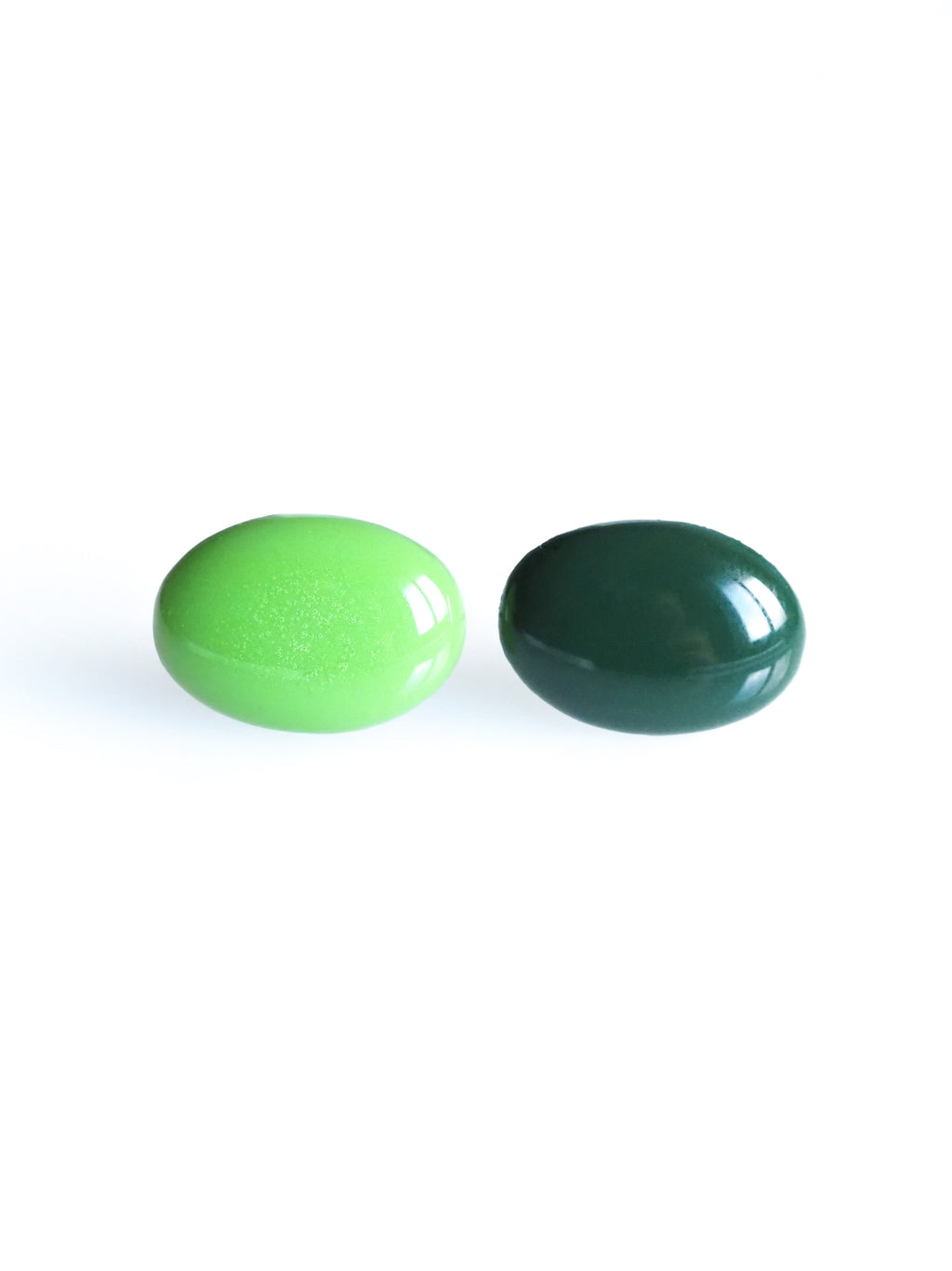 Solo resin stud earrings from the Chroma collection in grass and forest green on a white background