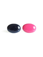 Solo resin stud earrings from the Chroma collection in ink blue and candy pink on a white background