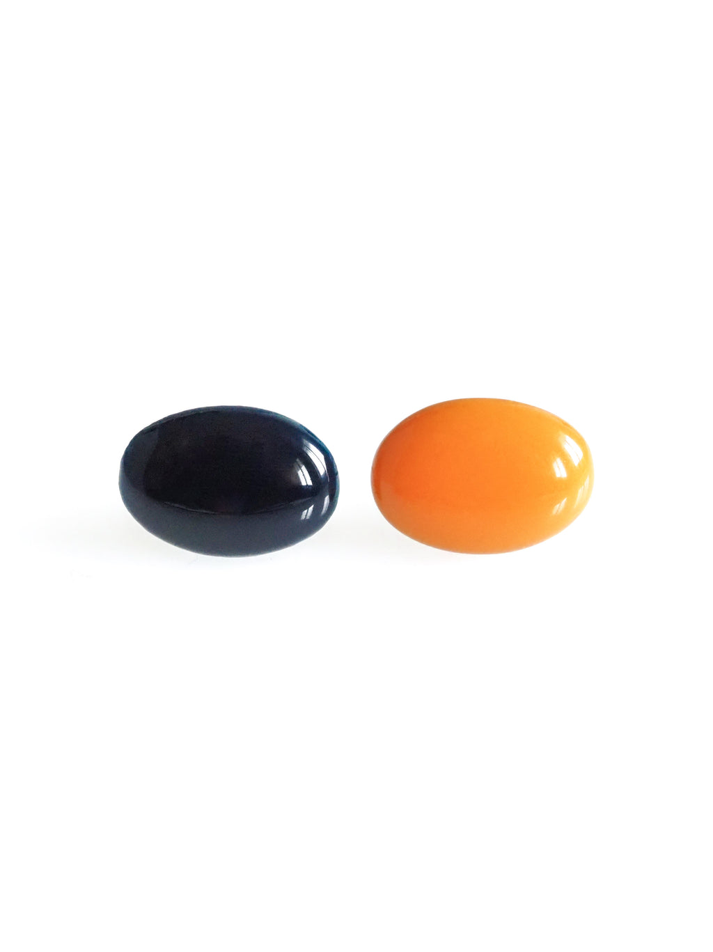 Solo resin stud earrings from the Chroma collection in ink blue and orange on a white background