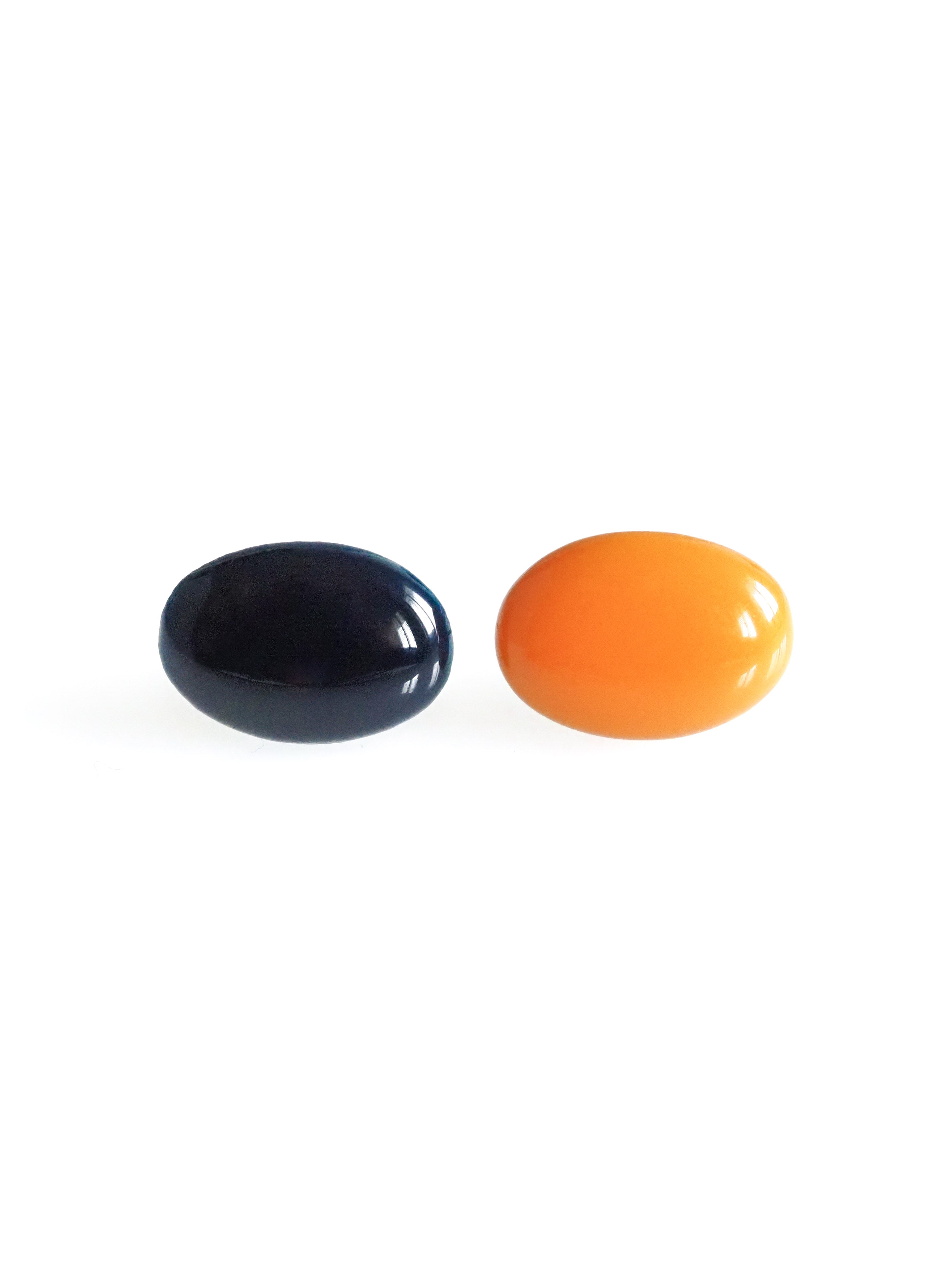 Solo resin stud earrings from the Chroma collection in ink blue and orange on a white background