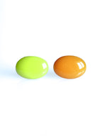 Solo resin stud earrings from the Chroma collection in electric lichen and orange on a white background