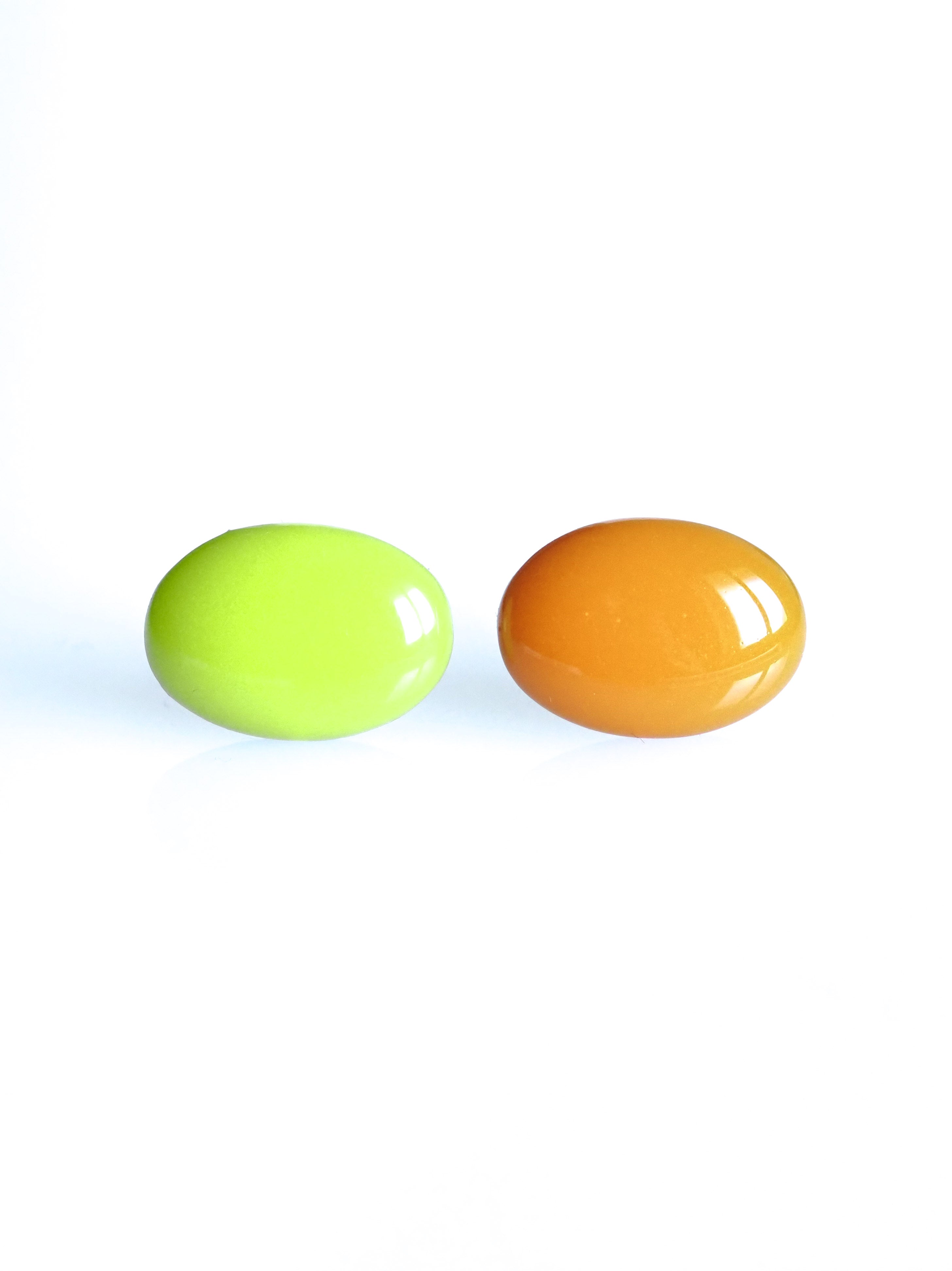 Solo resin stud earrings from the Chroma collection in electric lichen and orange on a white background