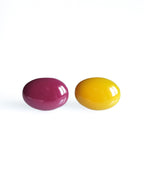 Solo resin stud earrings from the Chroma collection in mulberry and marigold yellow on a white background