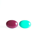 Solo resin stud earrings from the Chroma collection in mulberry and turquoise on a white background
