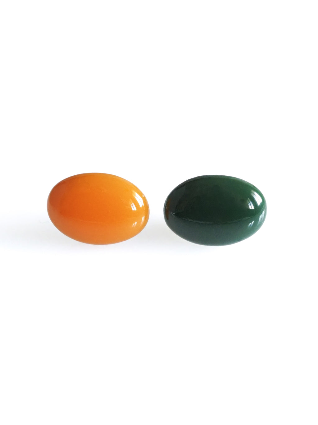 Solo resin stud earrings from the Chroma collection in orange and forest green on a white background